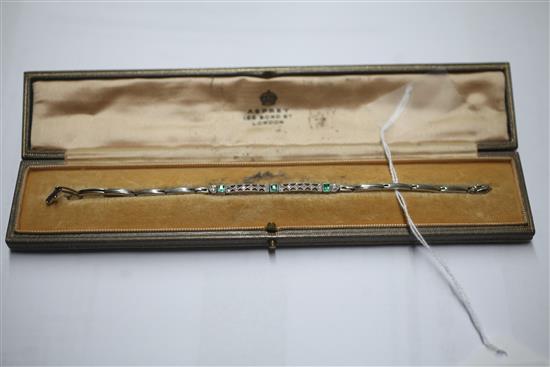 A 1920s 18ct white gold and platinum, emerald and diamond bracelet, in a fitted Asprey, London box.
